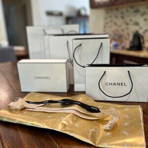 Assorted authentic Chanel gift bags, wrapping paper and ribbons
